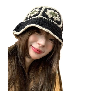 Handmade crochet floral bucket hat in black with beige and green knit patterns