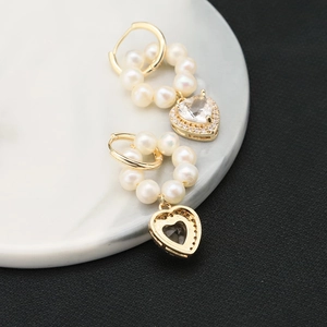 Elegant gold heart earrings with natural pearls and sparkling zircon pendants for women
