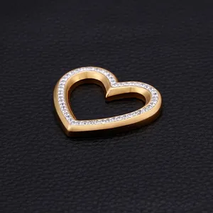 Gold plated stainless steel heart pendant with crystal rhinestones on leather background