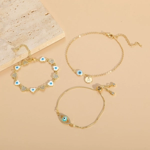 14K gold plated bracelets with evil eye and heart charms featuring blue enamel details