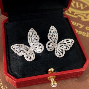 Detailed view of silver butterfly earrings with sparkling cubic zirconia in red gift box