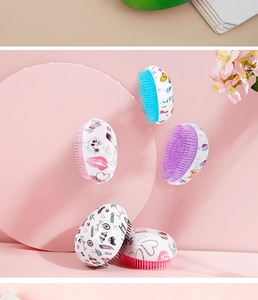 Close-up of colorful egg-shaped detangling hairbrushes with cartoon patterns for kids