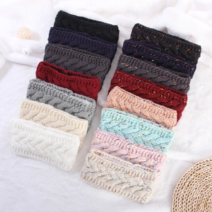 Detail view of cable knit headbands with fleece lining in various solid and speckled colors