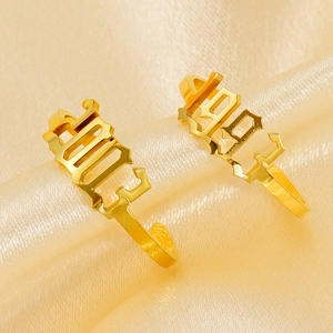 Close-up of 1993 and 2003 gold plated year rings on luxury silk background