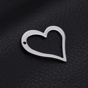 Polished stainless steel hollow heart pendant with dual holes on black leather background