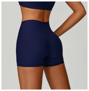 Detail showing the ribbed fabric and booty lifting seam of dark blue high waist yoga shorts
