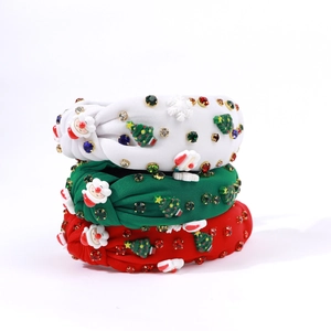 Detailed view of Christmas headbands with fabric knots, resin Santa, and shiny rhinestones