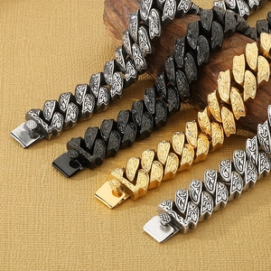 Detailed macro view of retro heavy Cuban chain bracelets with baroque floral engravings
