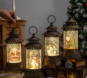 Detail of vintage bronze Christmas lanterns featuring Santa and Snowman with LED glitter glow