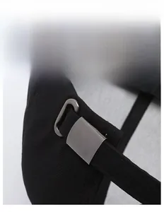 Detail view of the adjustable metal buckle and cotton canvas strap on a black baseball cap