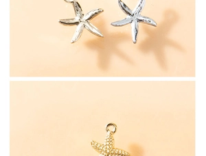 Macro detail of starfish shaped pendants in silver and gold plated metal finishes
