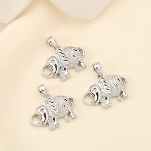 Macro shot of silver elephant charms with detailed textures and glossy metallic finish