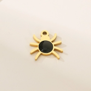 Detail of golden spider pendant with black inlay for Halloween jewelry making