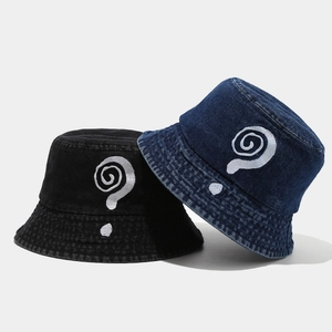 Close-up of embroidered swirl logo on black and denim blue cotton bucket hats