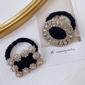 Macro detail of luxury rhinestone elastic hair tie and floral crystal pony holder