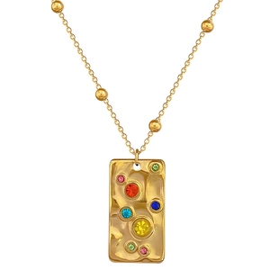 Irregular square gold necklace with colorful gemstones on a clean white background