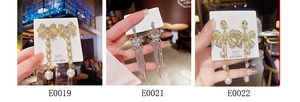 Macro view of geometric fringe earrings with S925 silver needles and pearl bow details