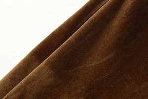 Close-up of premium coffee brown velvet fabric showing luxurious soft texture and sheen