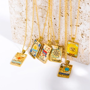 Close-up of golden tarot card necklaces featuring Sun and Moon enamel rectangle pendants
