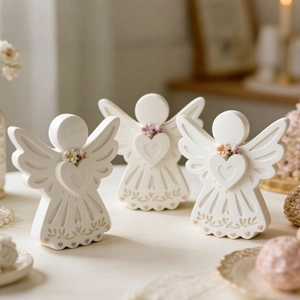 Elegant white angel figurine with heart relief and floral details for home decor