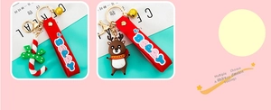Detail of Christmas silicone keychain with cute reindeer, candy cane and golden bell