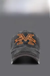 Detail of vintage washed charcoal cotton cap featuring orange 3D embroidered letter M