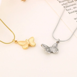 Detailed close-up of butterfly pendant necklaces in gold and silver stainless steel