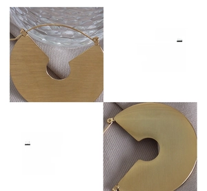 Macro shot of 18K gold plated titanium steel fan-shaped earrings with brushed texture