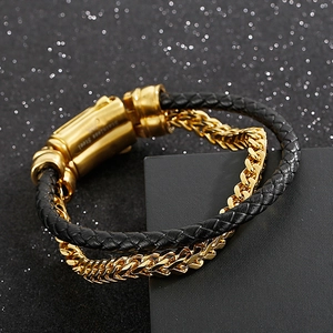 Detail of men's double-layer black braided leather and gold stainless steel chain bracelet