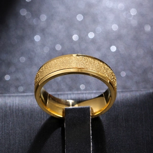 Macro shot of a 6mm gold titanium ring with a matte sandblasted finish and polished edges