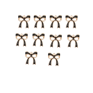 Flat lay of 10 black enamel and gold-edged alloy bow charms with top hanging loops