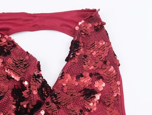 Close-up of sparkling red sequins on mesh fabric with halter neck binding detail