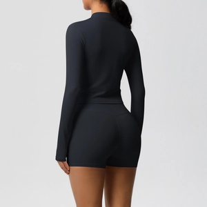 Detail of black slim-fit yoga set with high-waist shorts and full-zip sports jacket