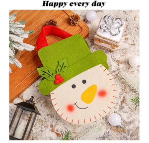 Detail of Christmas snowman felt gift bag with red berries and festive ornaments