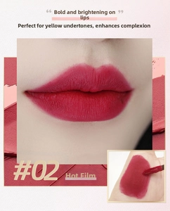 Macro detail of matte velvet liquid lipstick in red-pink shade with soft applicator brush