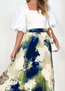 Detail of high-waist pleated skirt with abstract oil painting print and fluid silhouette