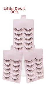 Detail view of 15 pairs of Little Devil style false eyelashes in stacked packaging boxes