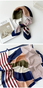 Detail view of geometric silk scarf in navy and salmon pink with striped patterns