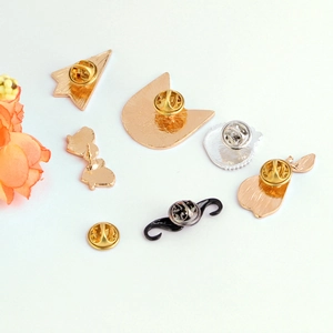 Detailed view of various enamel brooch alloy bases with butterfly clutch pin backings