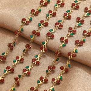 Macro shot of cherry-shaped gold plated stainless steel jewelry chain with red crystals