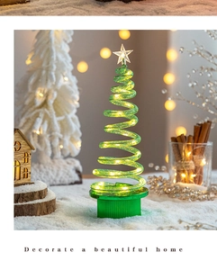 Close-up of spiral LED Christmas tree with star topper in cozy holiday scene