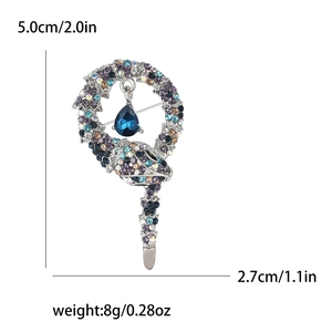 Detail view of rhinestone snake brooch with measurements 5.0cm length and 8g weight