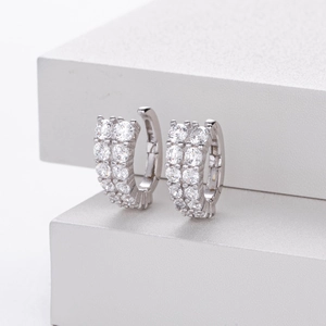 Detail of silver S925 trapezoid hoop earrings featuring double rows of white cubic zirconia