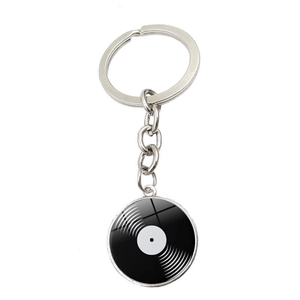Detail of a retro vinyl record keychain featuring silver metal frame and glossy glass dome