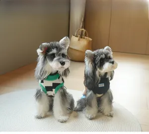 Detail of soft knit pet vests with argyle pattern and Gentle Dog patch on Schnauzers