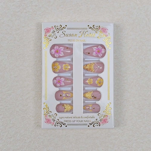 Detail of almond 3D press-on nails with cherry blossoms, pearls and star sequins