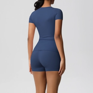 Rear view of tight-fit navy blue sports set featuring short sleeves and high-waist shorts