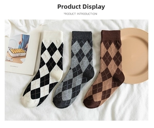 Detailed view of diamond pattern cotton crew socks in black, grey, and brown colors