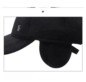 Detail of winter baseball cap showing foldable ear flaps and silver metal shield logo