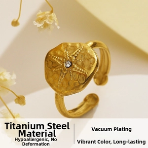 Macro shot of 18k gold plated stainless steel ring with star engraving and small diamond
